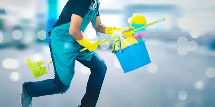Close up male janitor flying with broom