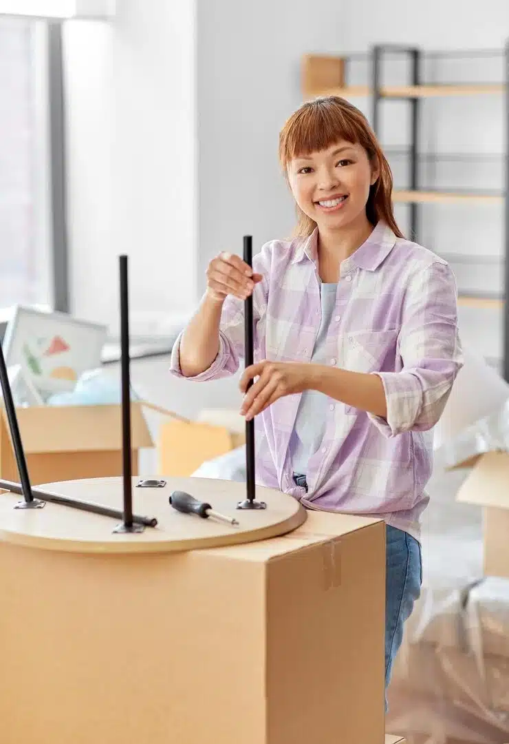 Happy woman assembling coffee table home